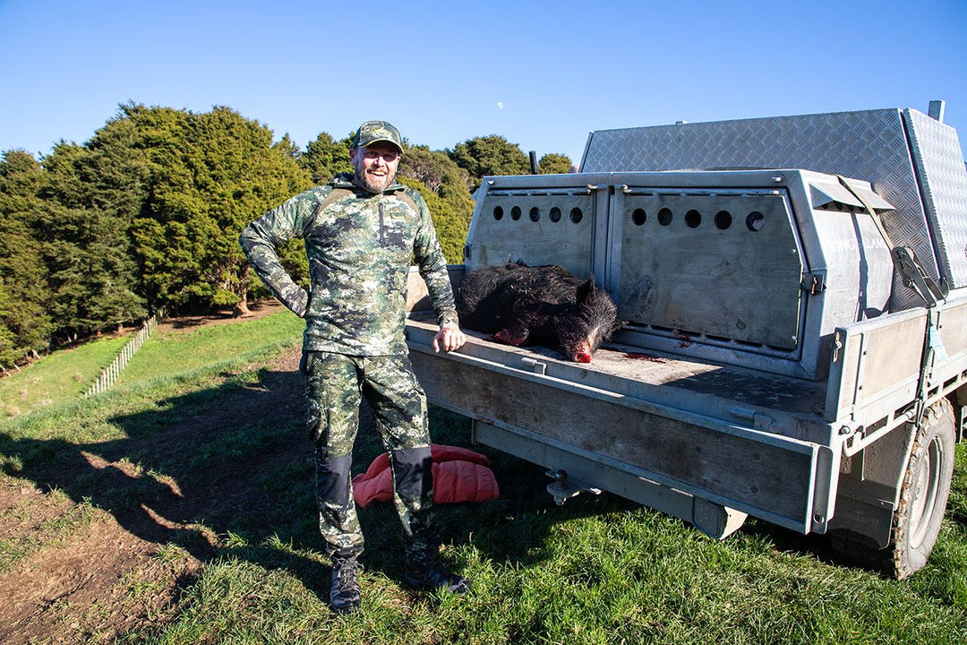 Chris posing with a pig that he and fellow hunters took down 